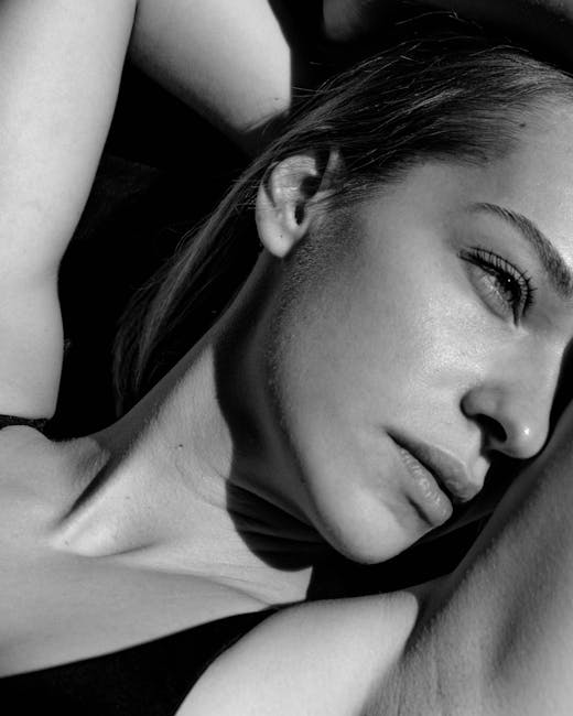 Serene black and white close-up portrait focusing on a woman's contemplative expression.