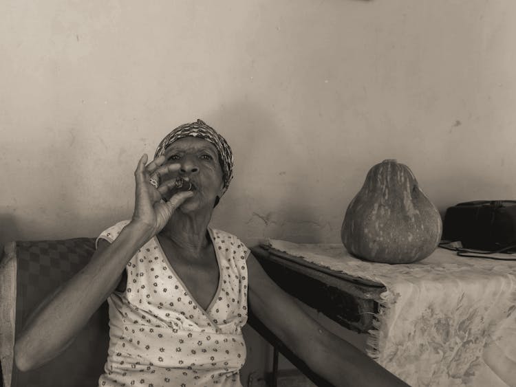 A Woman Smoking A Cigar