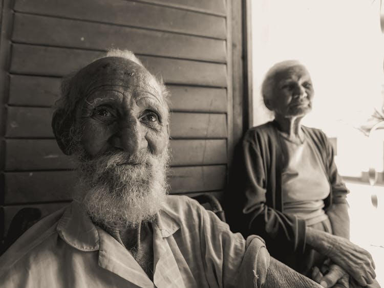 Elderly Man And Woman Sitting Next To Each Other 