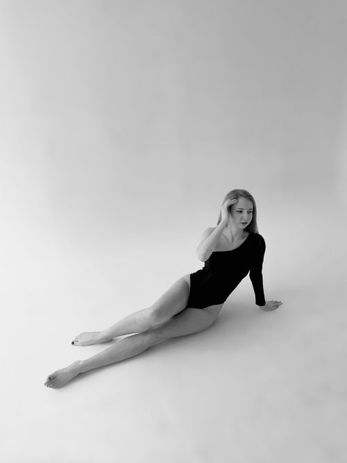 Free Elegant black and white portrait of a woman posing in a studio wearing a bodysuit. Stock Photo