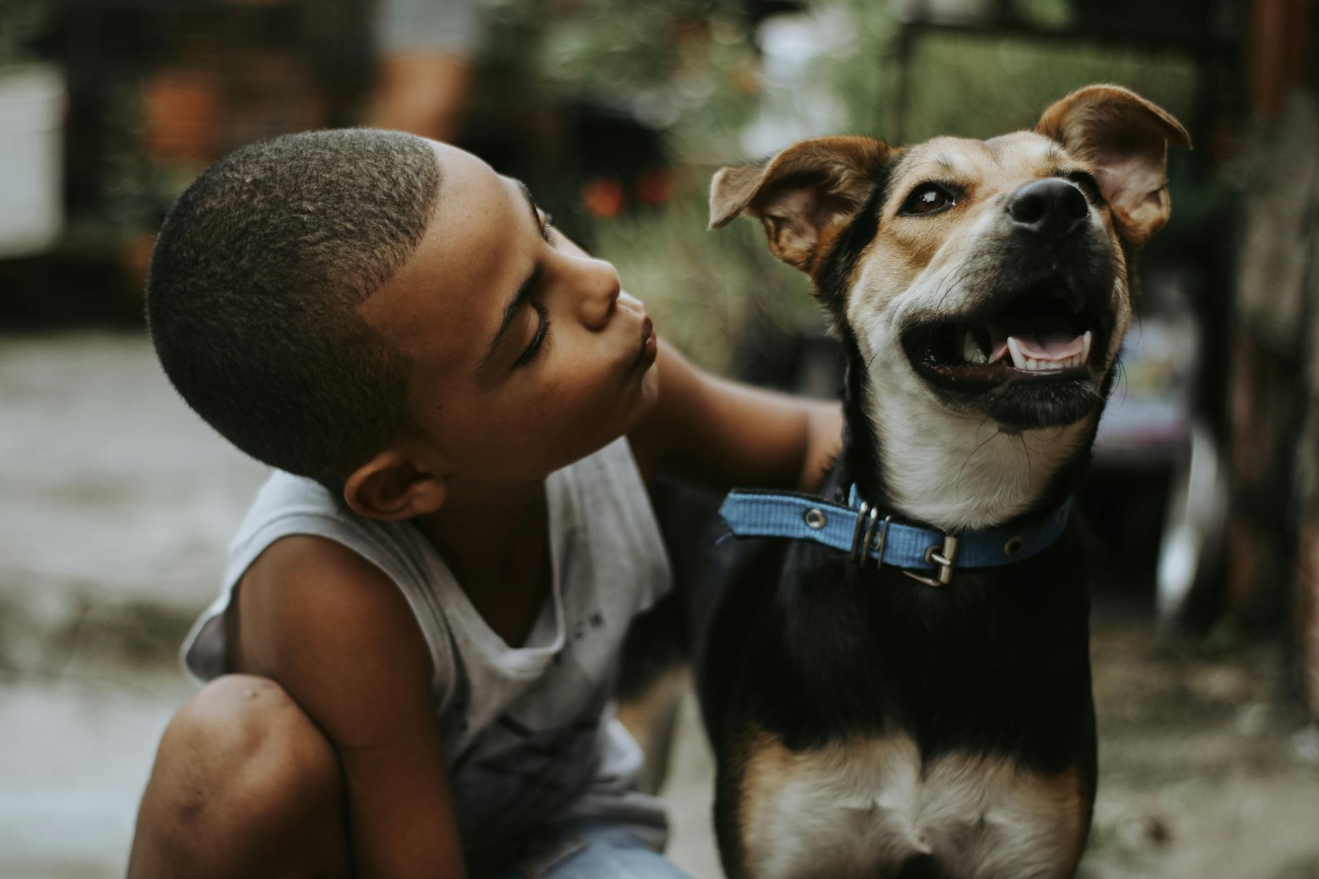 Boy Giving a Kiss to his Dog