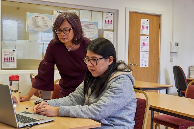 Two Women Looking At The Laptop