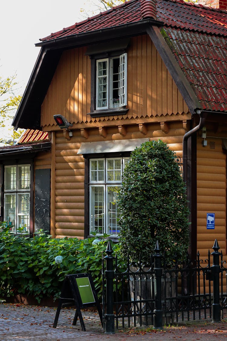 Brown Wooden House With Green Plants