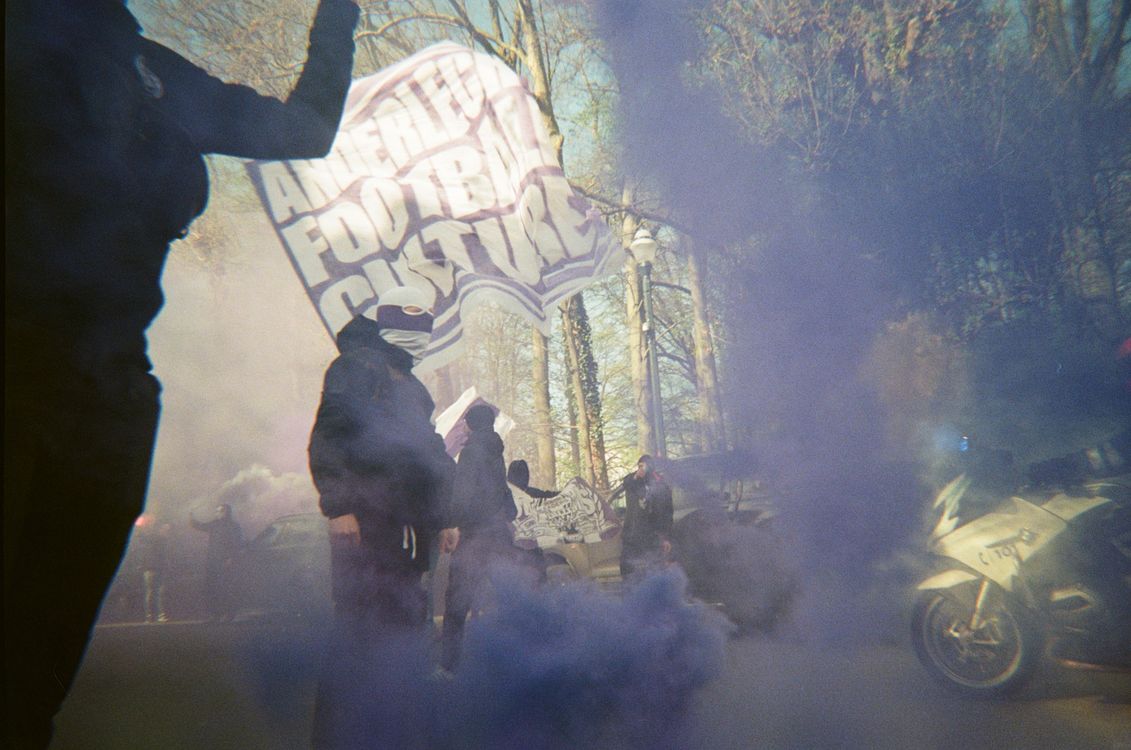 Free Protesters with banners and smoke on a street, creating a dynamic atmosphere. Stock Photo