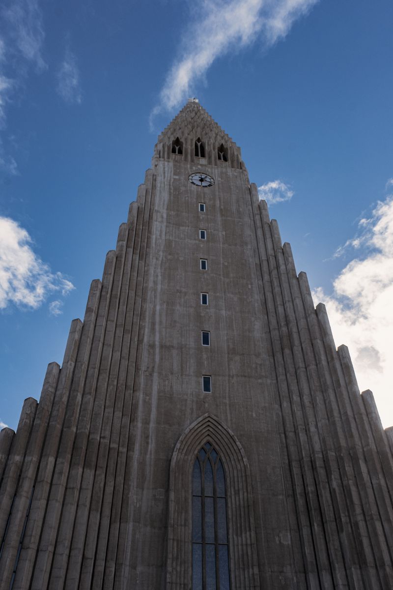 Low-angle view of the stepped concrete church tower in Reykjavik — photo by Monica Oprea on Pexels