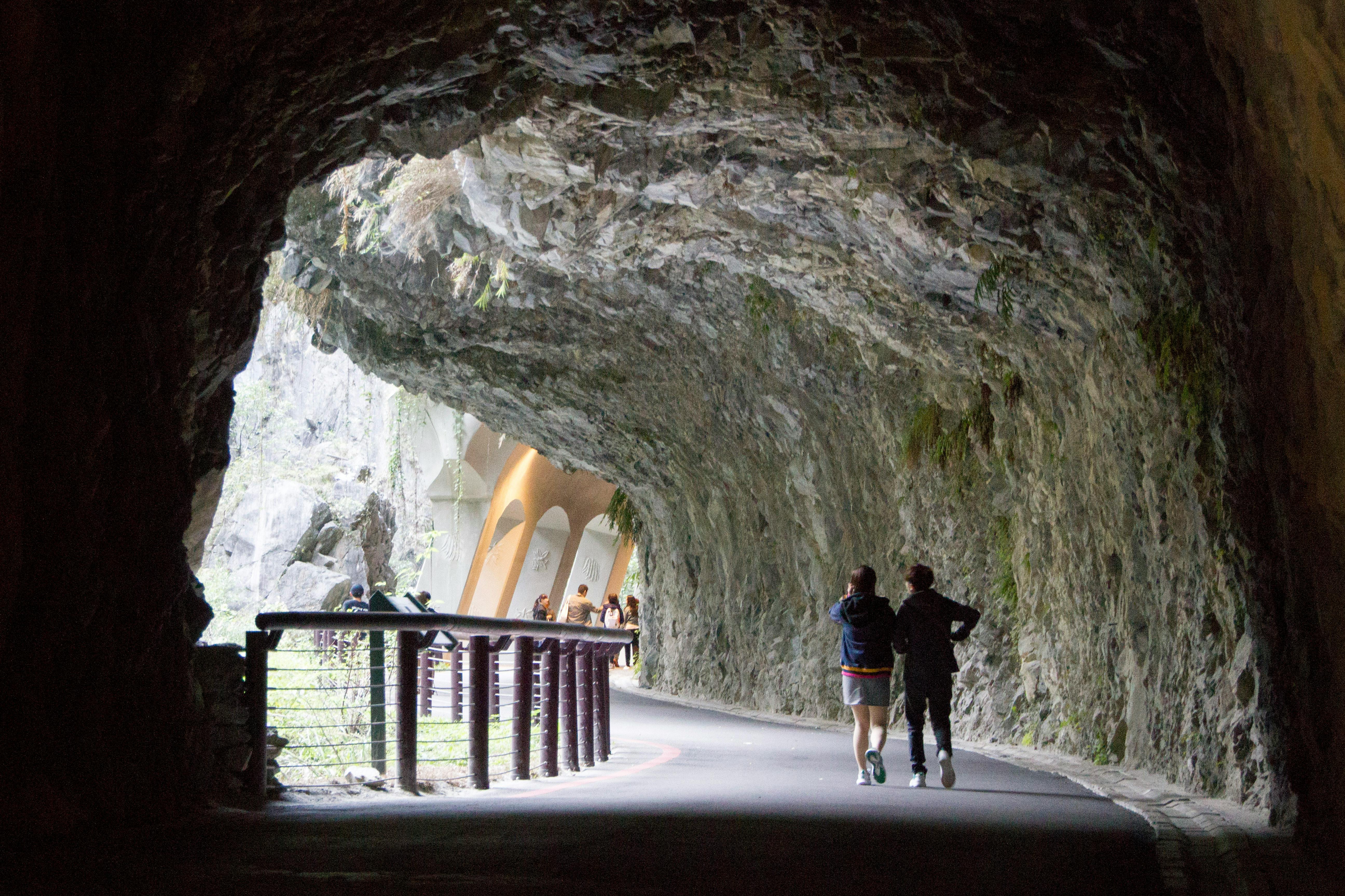 Tourists explore the scenic Shakadang Trail tunnel in Taroko National Park, Taiwan.