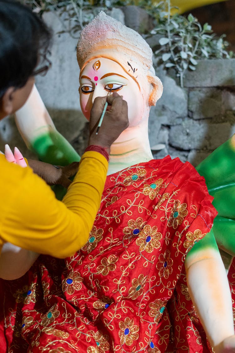 Person Painting A Statue