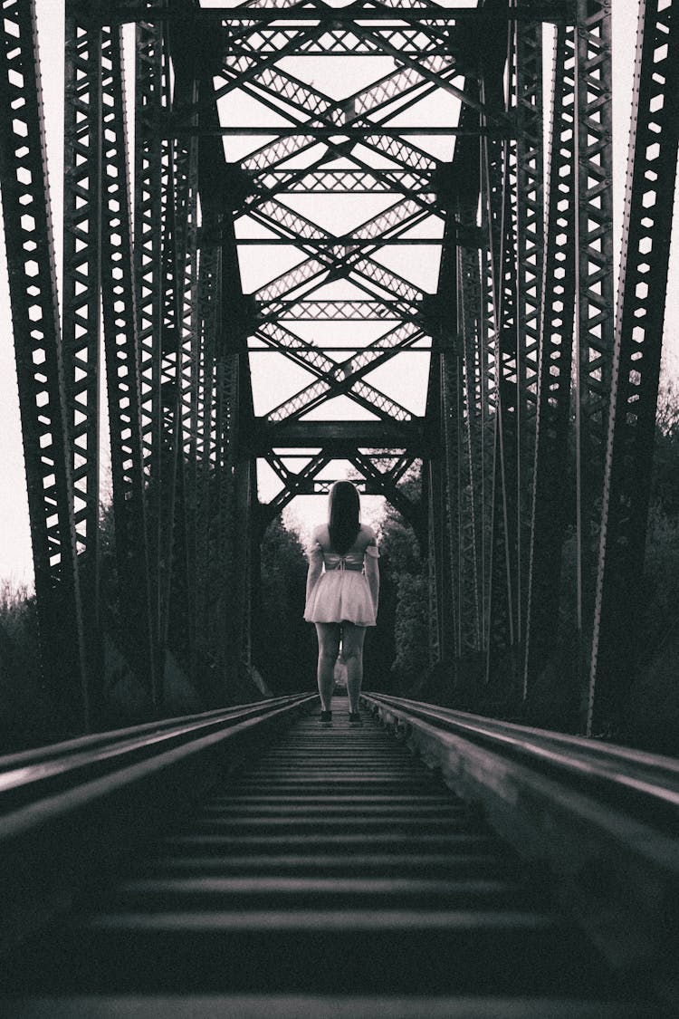 Woman Standing On Railroad Bridge