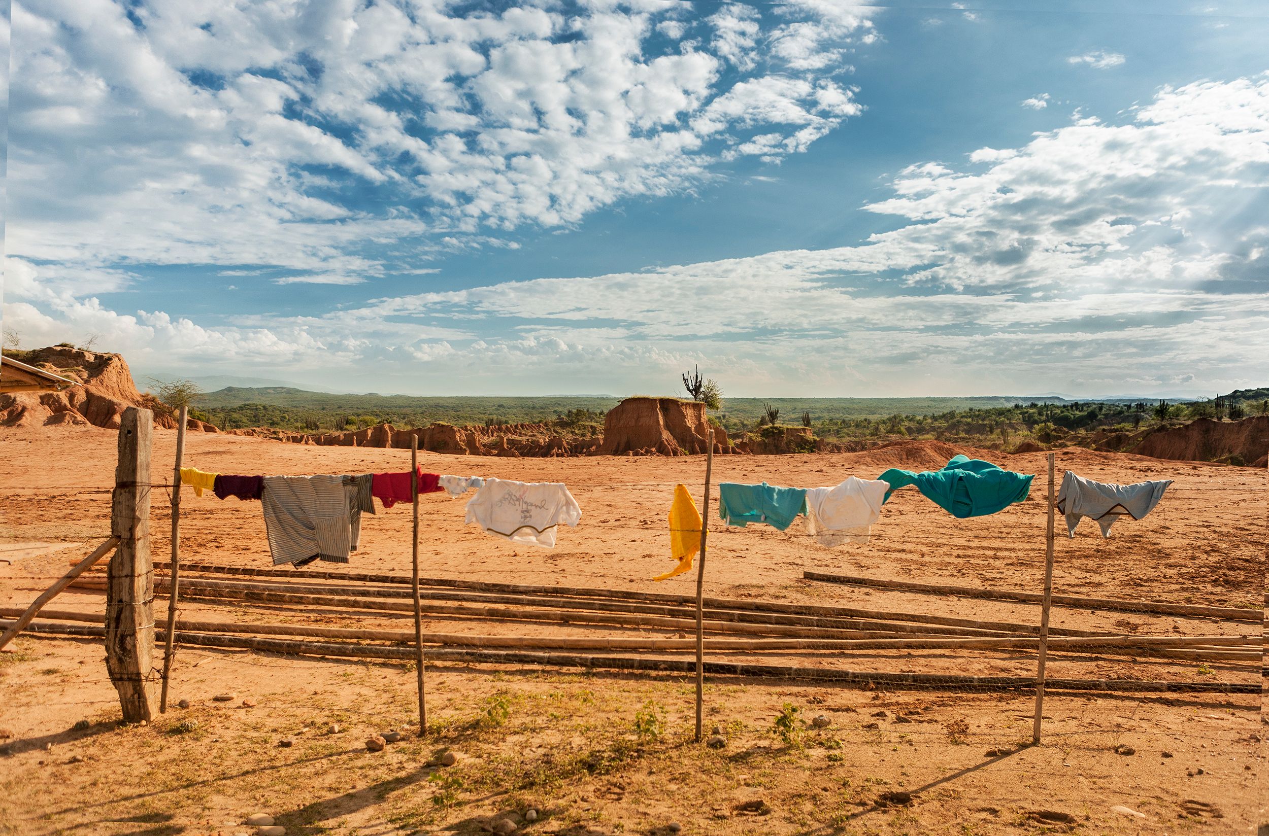 Clothes hanging on a line in a sunny countryside landscape with blue skies.