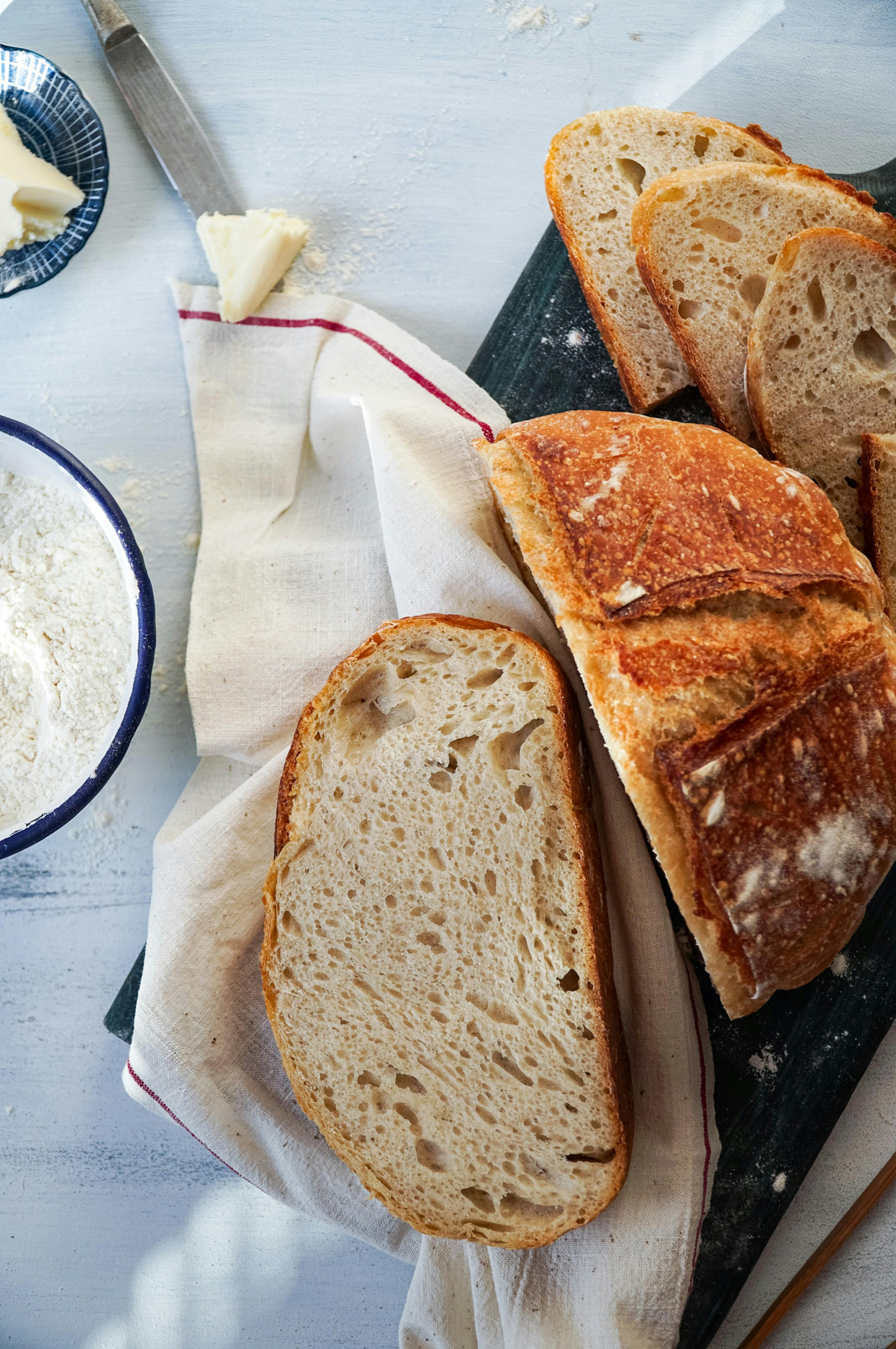 A delicious loaf of sliced bread on a wooden board, perfect for breakfast.