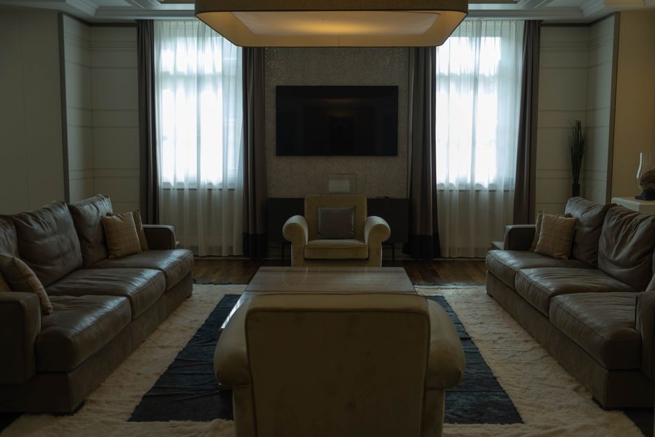 Luxurious dark living room with warm ambient lighting and leather sofas