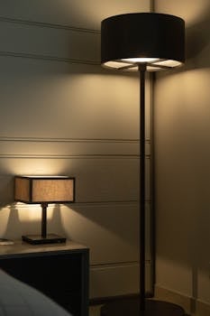 A cozy corner illuminated by modern floor and table lamps casting a warm glow.