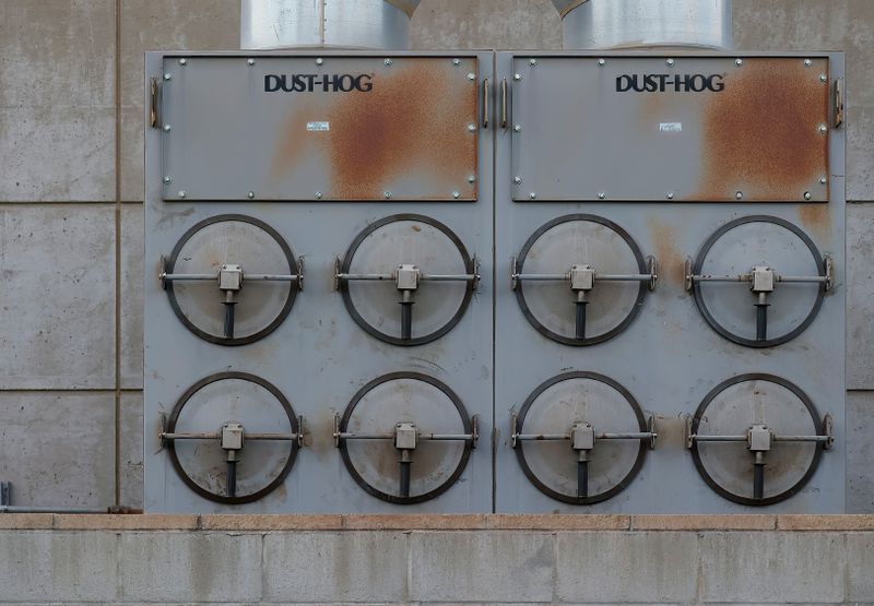 Close-up of a Dust-Hog industrial dust collector with six rusty filtration units