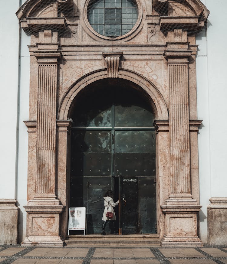 Woman Entering Ornamented Building