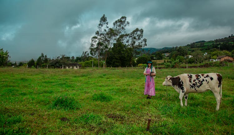 Woman Standing Near A Cow