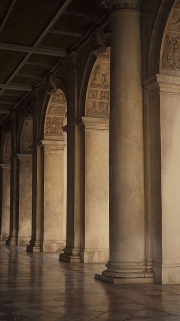 A timeless archway with intricate architectural details and elegant columns bathed in soft light.