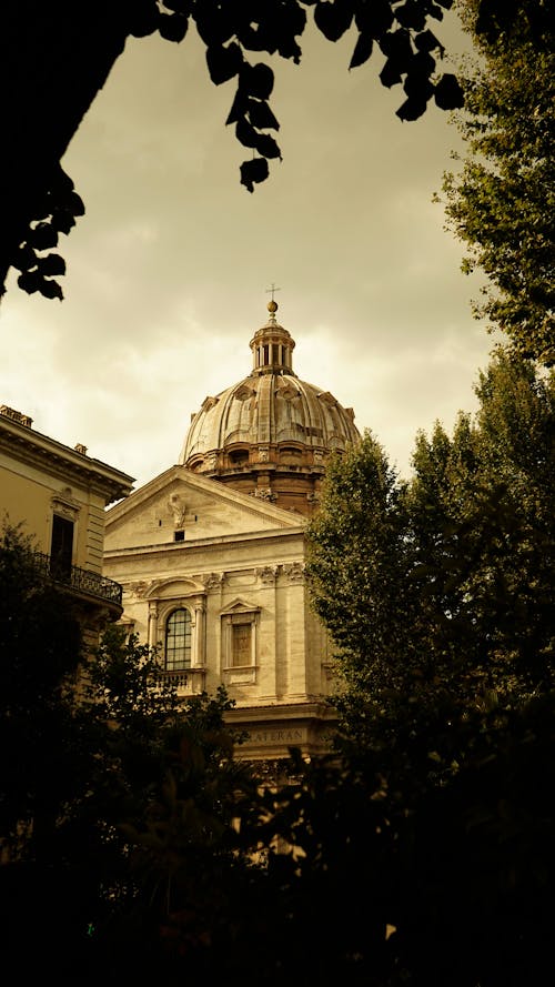 St. Peters Basilica Dome Visible Between Buildings in Vatican City, Italy 