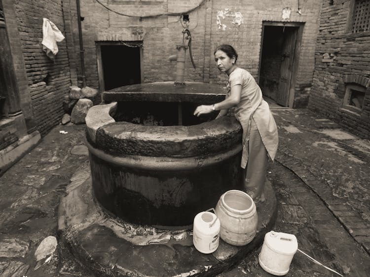 Woman Pulling Water Out Of Well