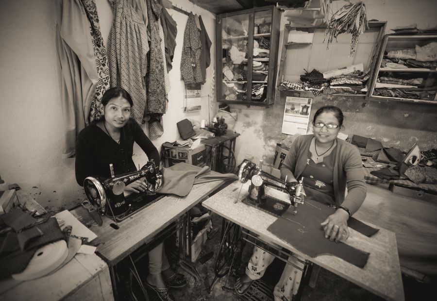 Women learning tailoring skills in a workshop in India