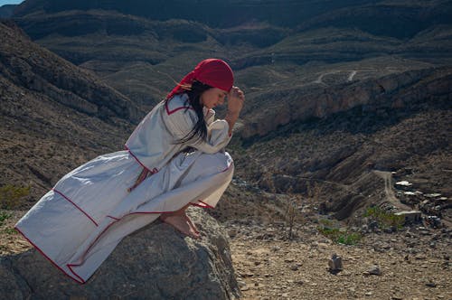Woman Praying on Mountain Top