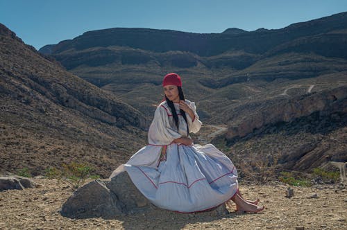 A Woman in White and Red Long Sleeve Dress