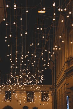 Charming evening scene of decorative lights hanging in a street of Cluj-Napoca, Romania.