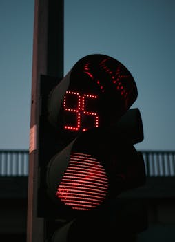 Red traffic light with a 95-second countdown during twilight, emphasizing urban traffic control.