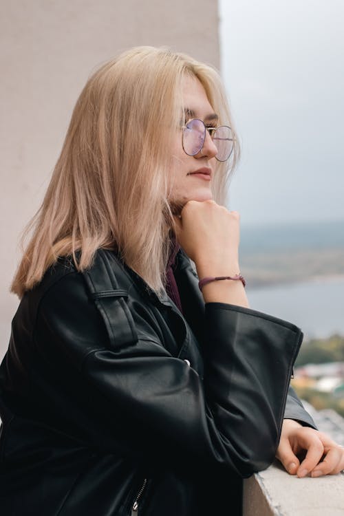 Woman in Black Leather Jacket Wearing Metal Framed Eyeglasses