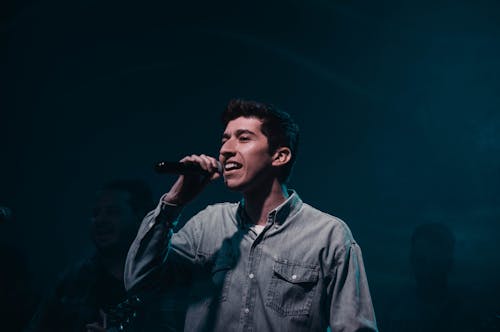 A Man Singing with a Microphone