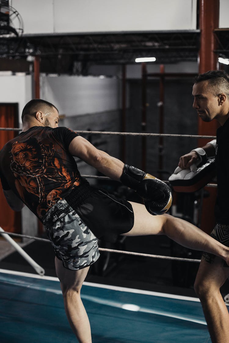 A Kick Boxer Training With A Coach