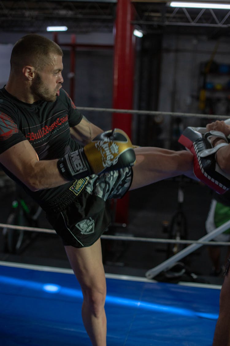 
A Man Kicking A Kick Pad