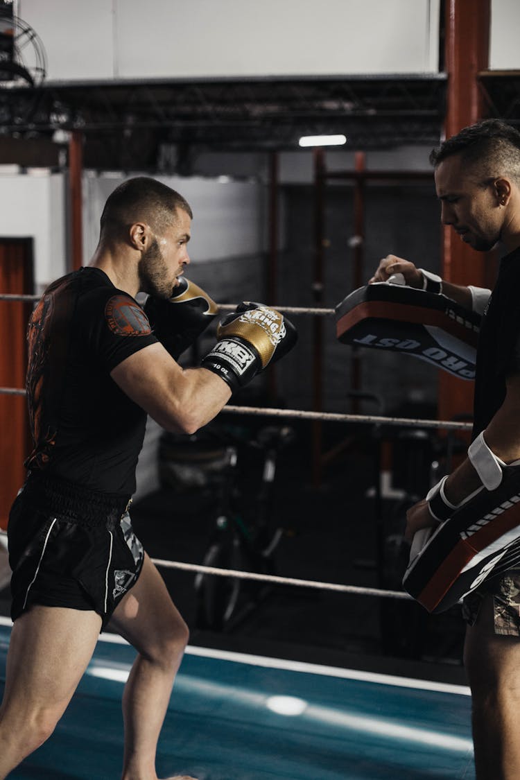 
A Kick Boxer Training With A Coach