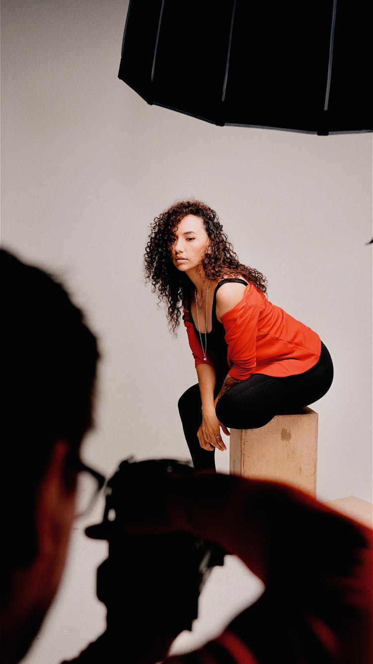 Man Taking A Photo Of A Woman In A Studio