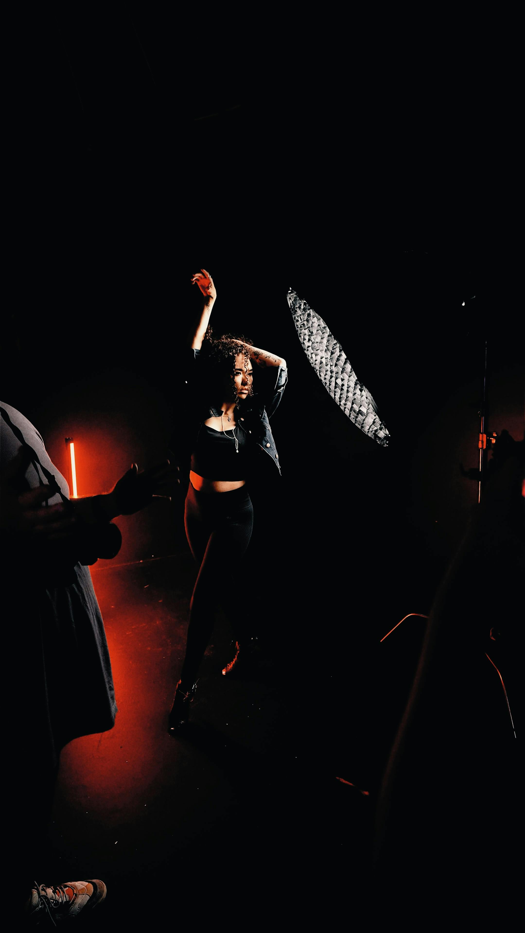 Free Fashion model posing with dramatic lighting in a studio. Ideal for fashion and editorial use. Stock Photo