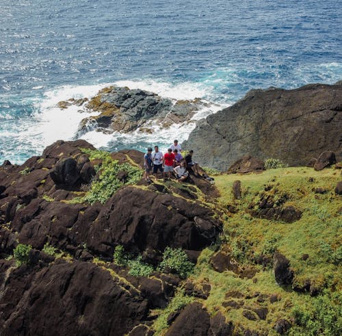 Group of People on Rocky Ocean Shore