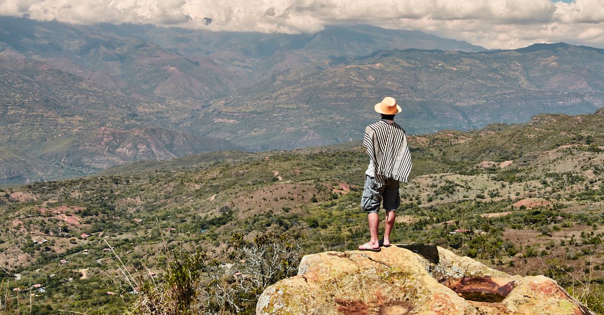 Man Standing on a Rock at the Edge of a Cliff · Free Stock Photo