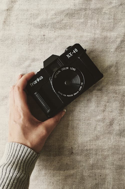 Free Person Holding Black Franka Nx-40 Slr Camera Stock Photo