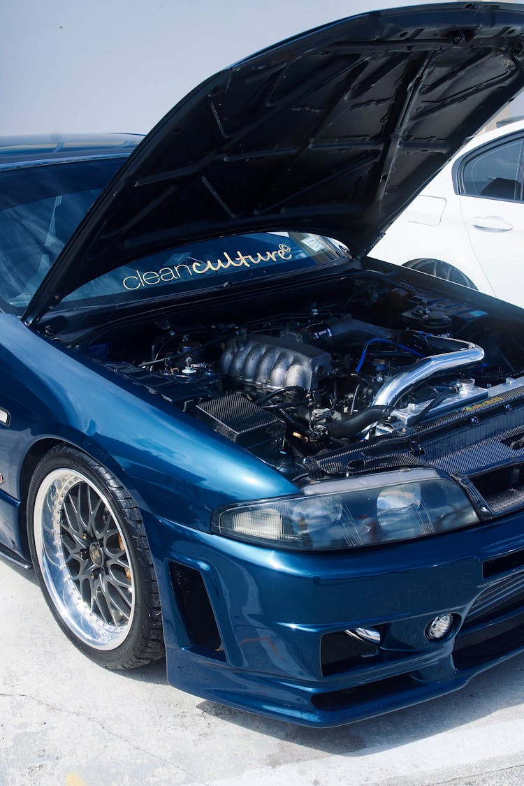 Open Hood Of A Blue Car