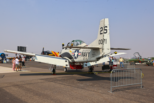 Free Static display of US Navy aircraft at an outdoor airshow with visitors. Stock Photo