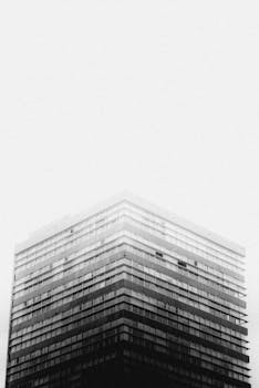 Striking monochrome image of a towering skyscraper under overcast sky in Mexico City.