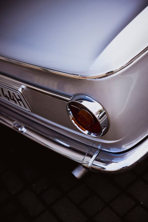 Tail Light of a Silver Classic Car 