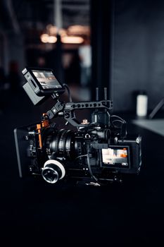 High-quality digital camcorder with mounted accessories in a professional studio environment.