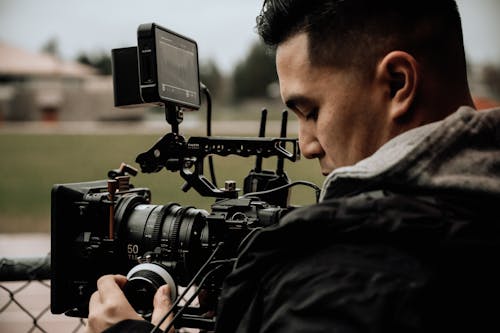 Free Man Operating a Camcorder  Stock Photo