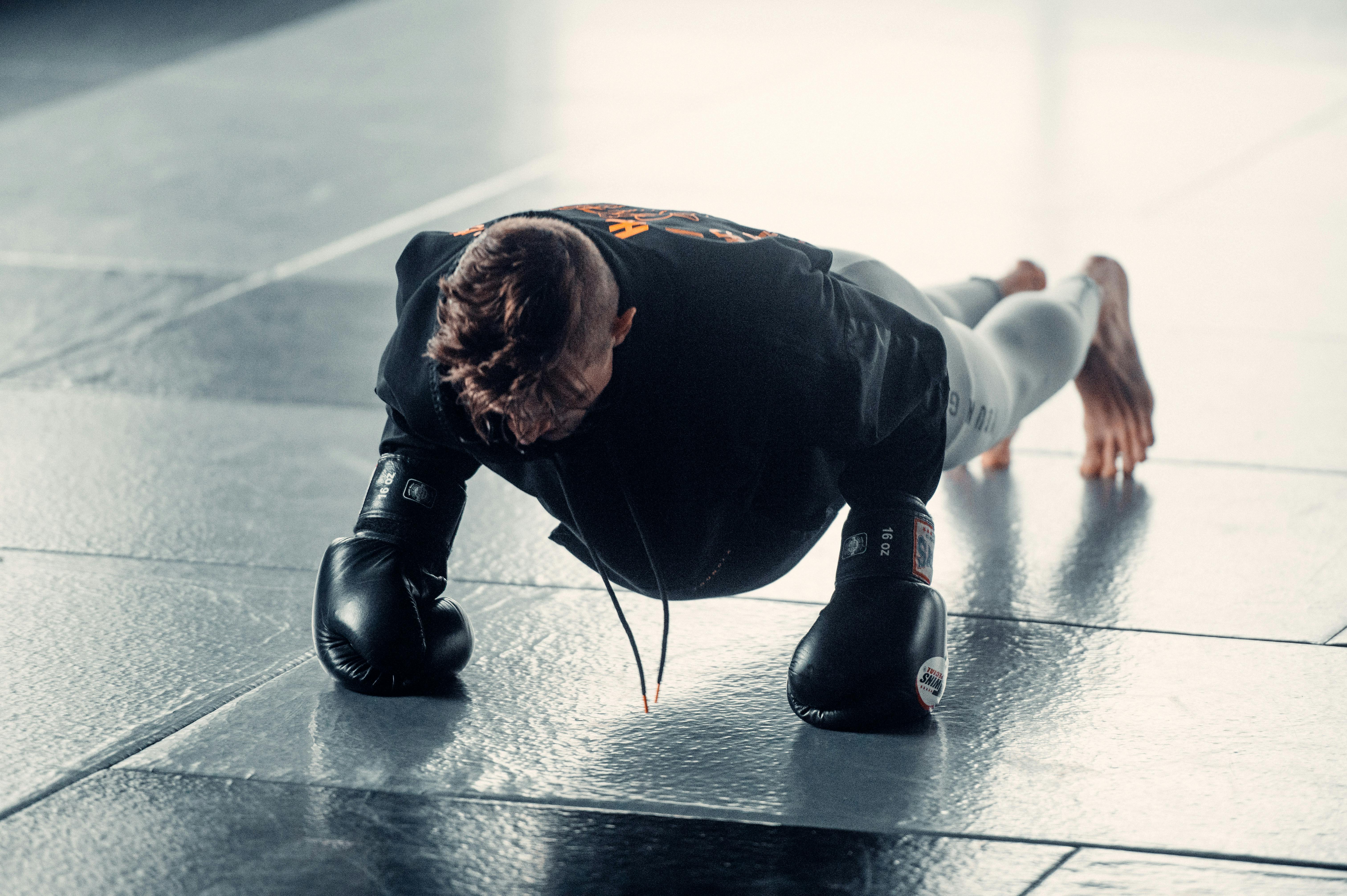 Man Practicing Pump Ups with Boxing Gloves · Free Stock Photo