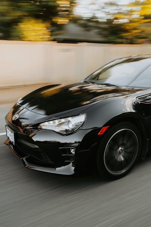 Black Sports Car Driving on the Highway