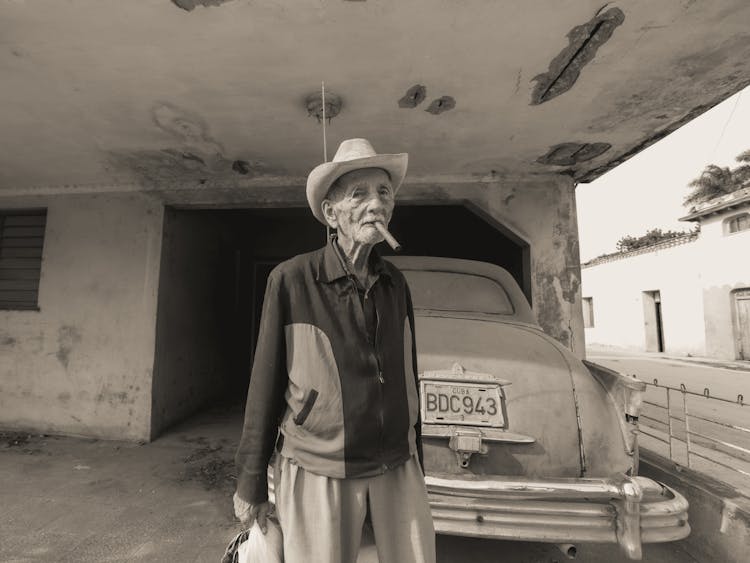 An Elderly Man Smoking Tobacco