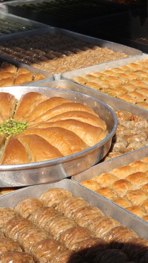 Free A close-up of assorted trays of Turkish baklava and pastries with a focus on texture and variety. Stock Photo