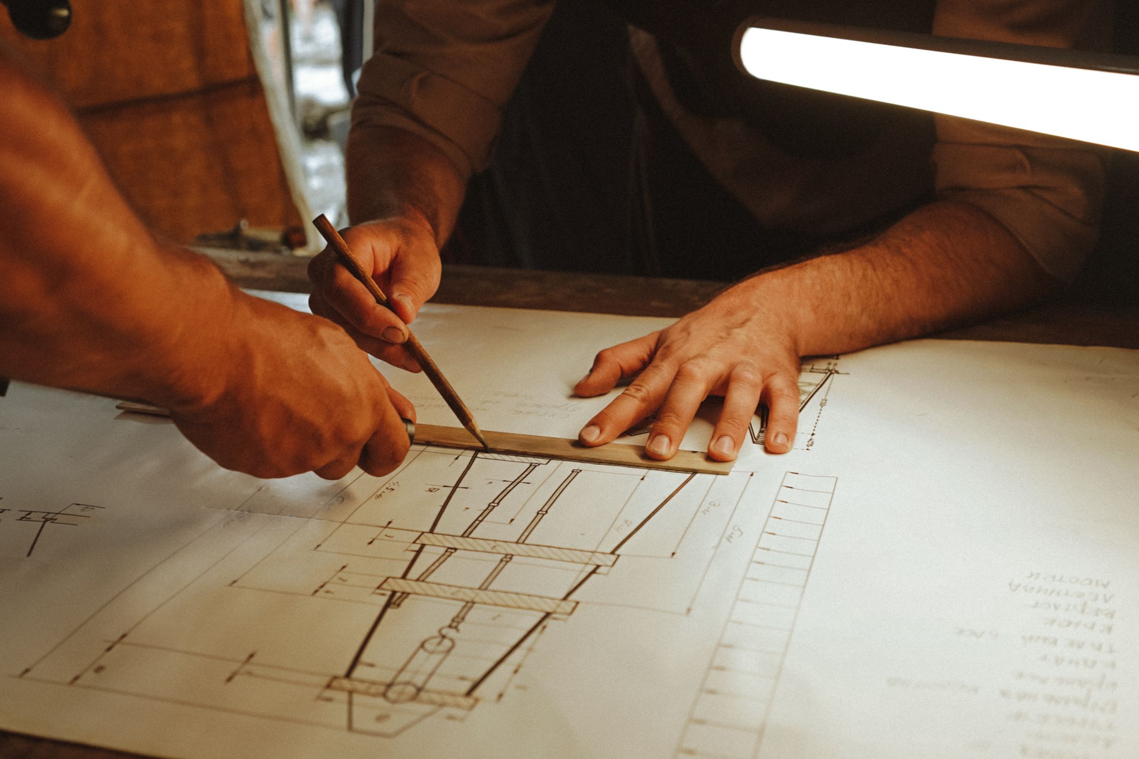 Development Drafting Men Creating an Architecture Construction Drawing · Free Stock Photo