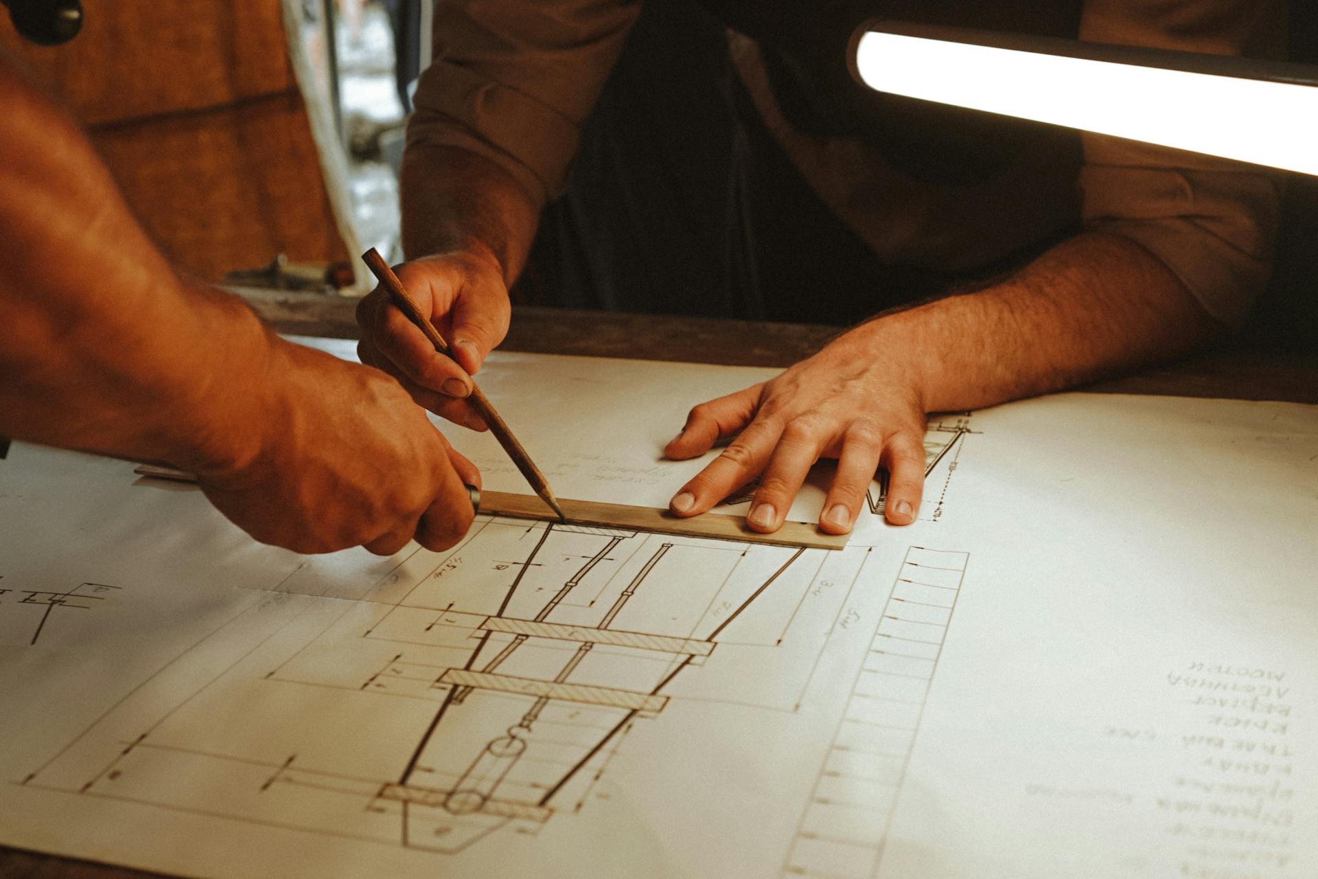 Men Creating an Architecture Construction Drawing