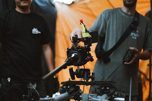Crew members using advanced camera equipment on set for professional filming.